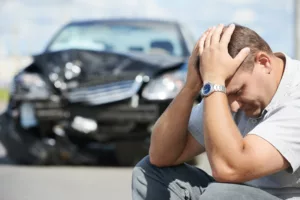 Man with head in hands infront of crashed car needing Vehicle Insurance in Allen, TX, Frisco, McKinney, Plano, Dallas & Nearby Cities 