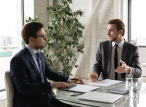 two employees discussing Business Insurance in Grapevine, McKinney, Plano, Richardson, Frisco & Surrounding Areas