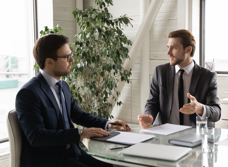 two employees discussing BOP insurance policies in Coppell, TX