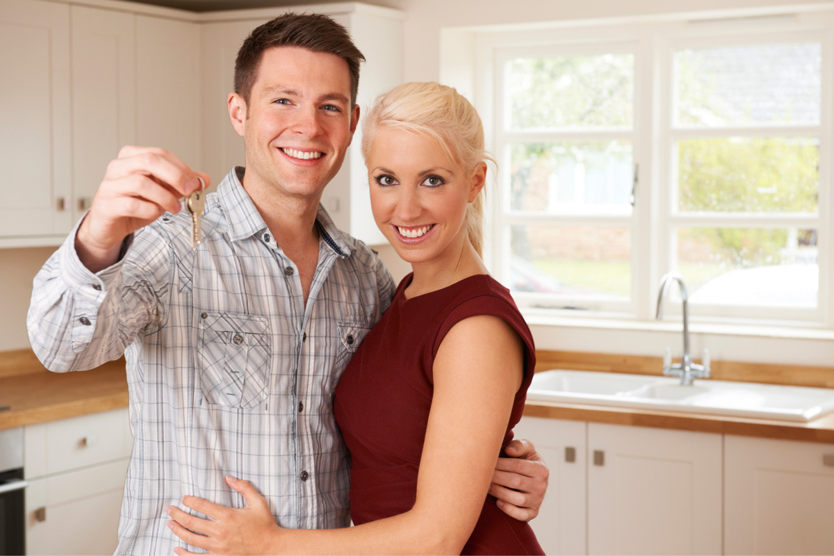 couple holding keys smiling with home insurance in Prosper, TX