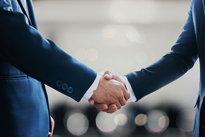 Business men using payment bonds shaking hands in Dallas County, TX
