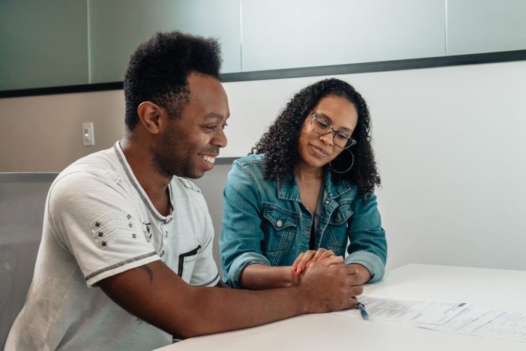 Couple reviewing paperwork together to decide what insurance do I need